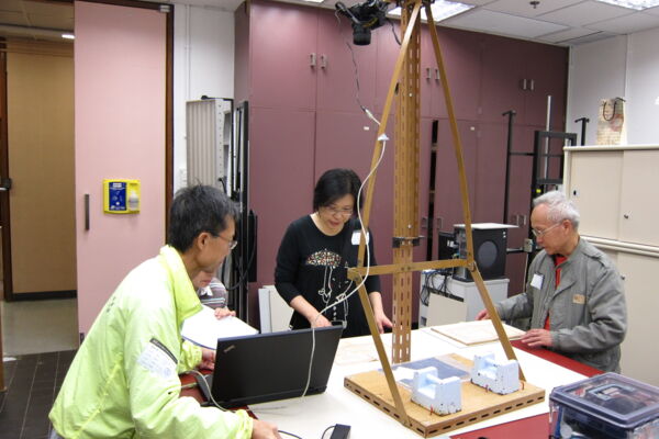 東華三院文物館義工正在拍攝修復後的文獻，以便日後查閱數碼檔案。